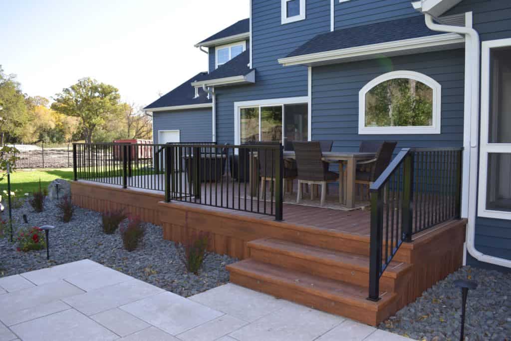 An image of Modern dark blue house with a spacious cedar deck for outdoor entertaining. 
