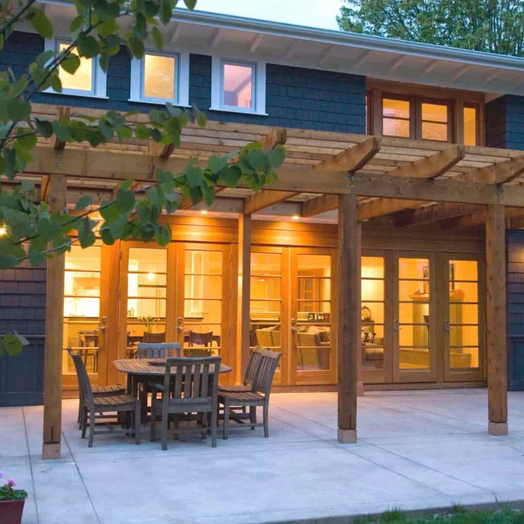 An image of Dark blue house with a beautiful cedar pergola.