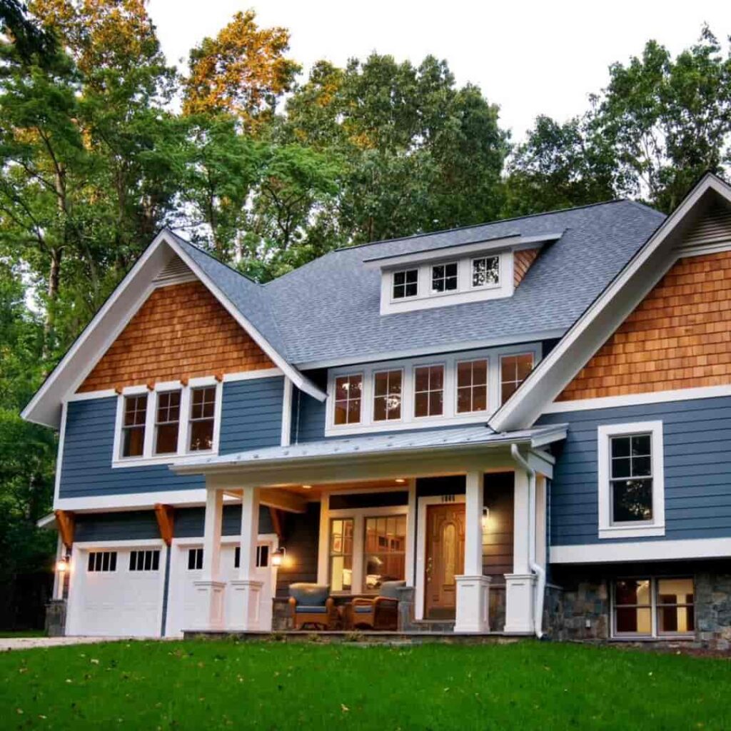 An image of Dark blue house with dual-tone cedar trim accents.